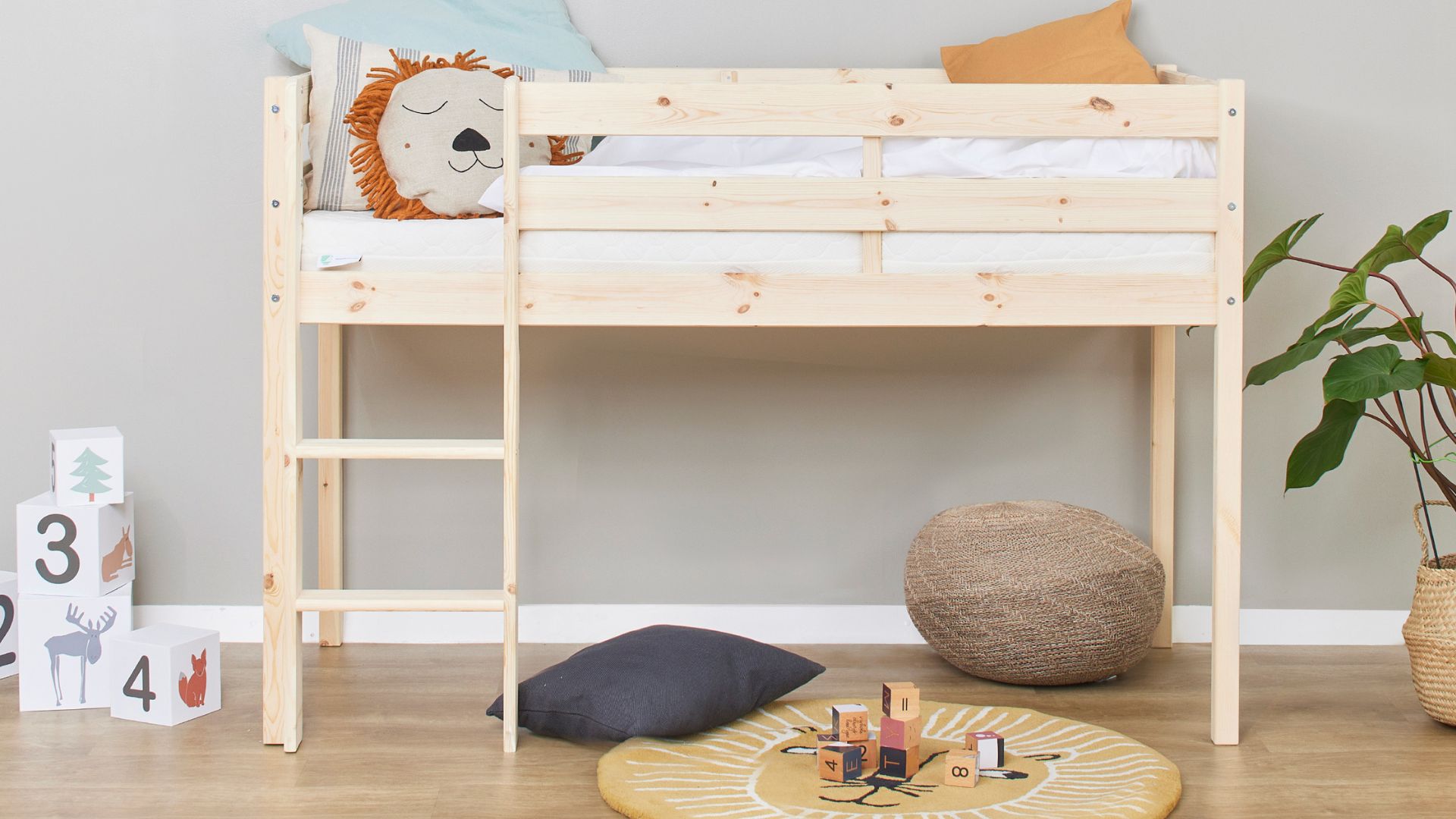 A loft bed with a free play area underneath in a child-friendly bedroom